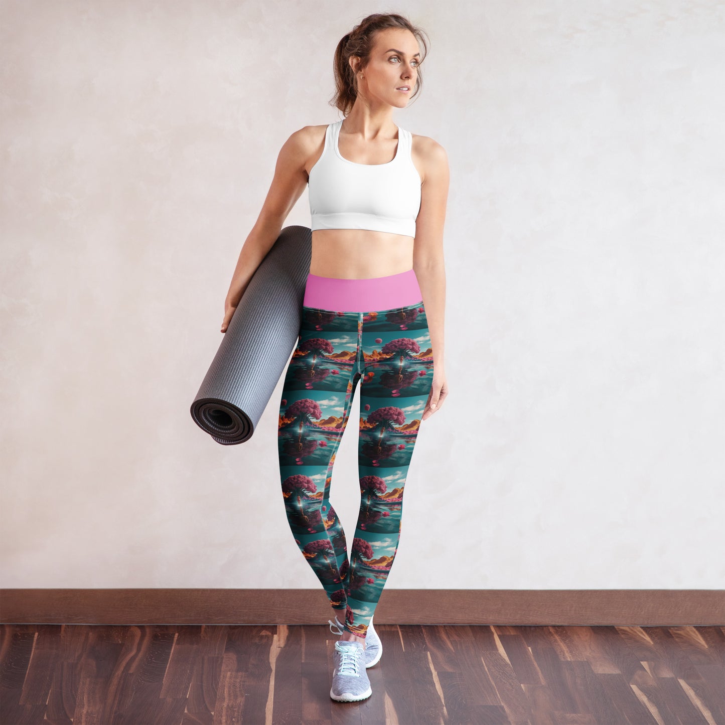 Women's yoga leggings on model, teal-and-coral print with pink waistband.