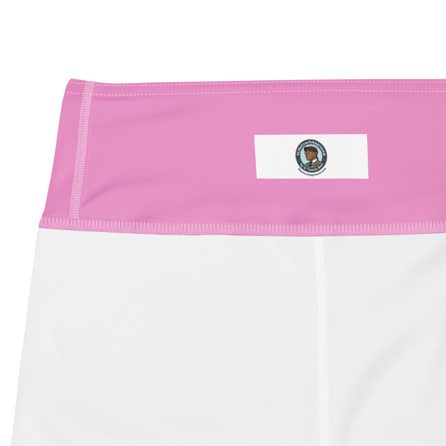 Pink waistband with rectangular logo patch and seam stitching on yoga leggings, close-up