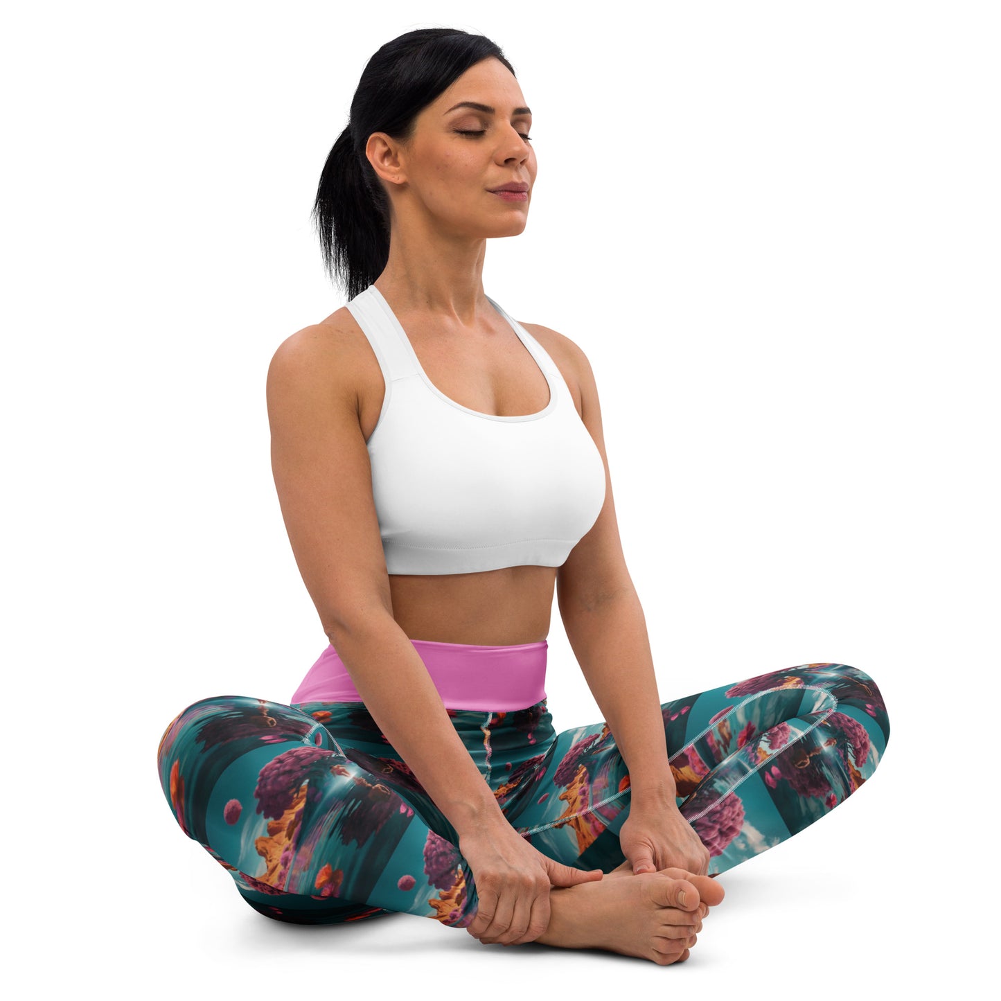 Teal patterned yoga leggings with pink waistband, side view seated stretch