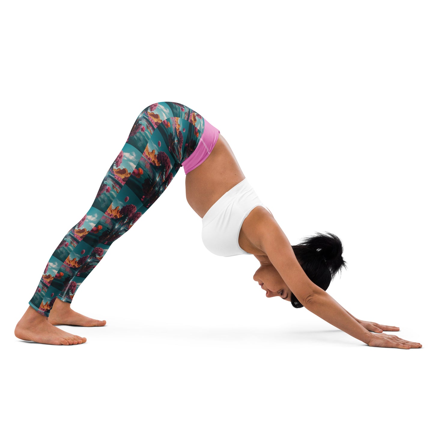 Teal yoga leggings with scenic landscape print and pink waistband, forward bend