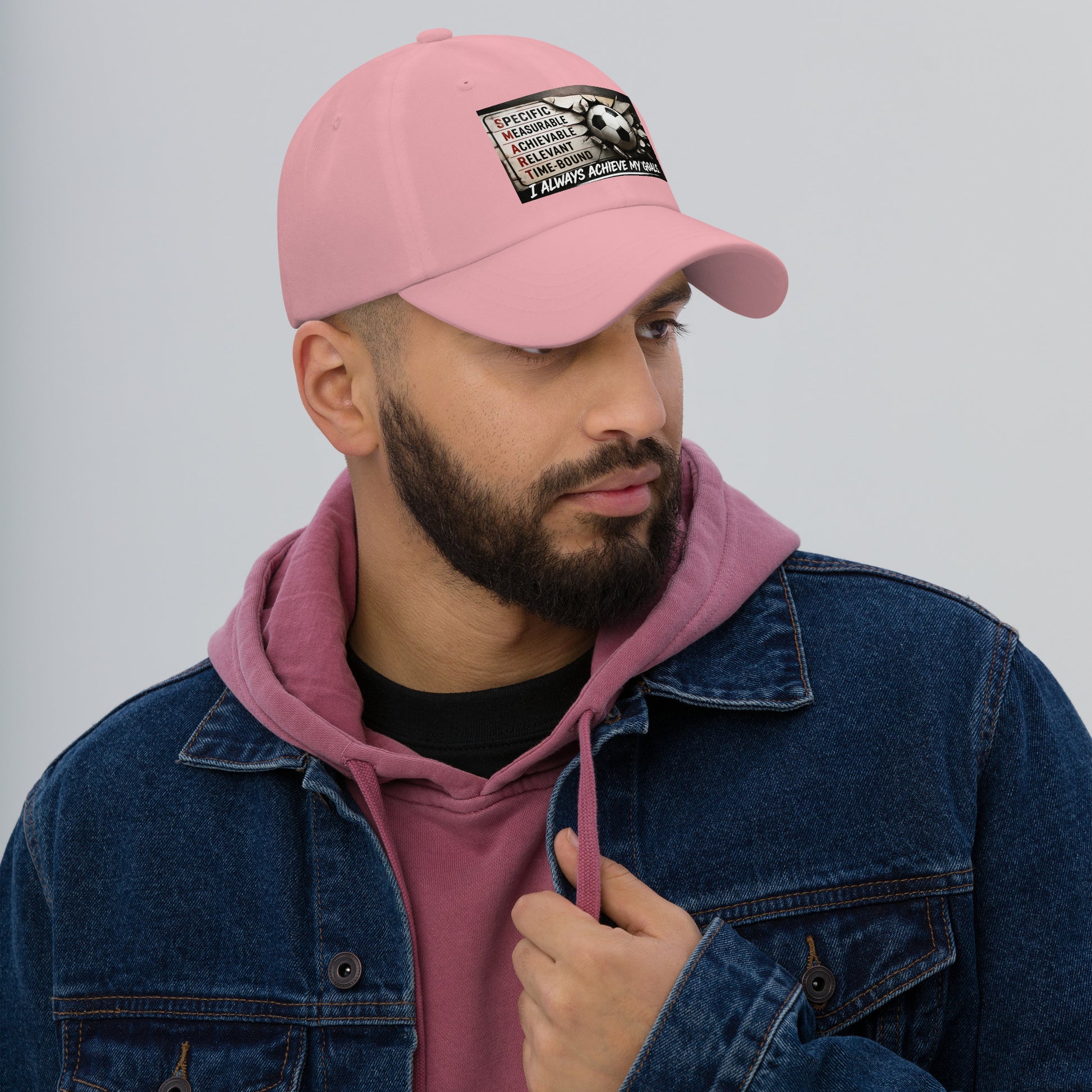 Pink dad hat with stitched front logo patch, curved brim and adjustable strap