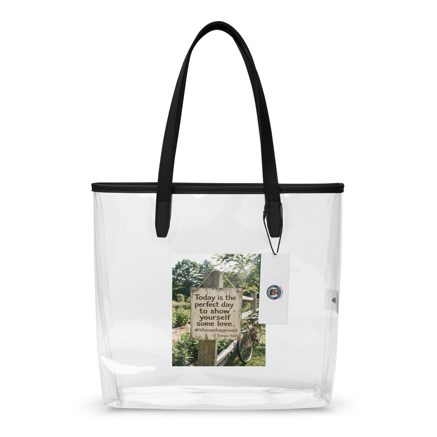 Clear tote bag with black handles and a printed inspirational panel on the front