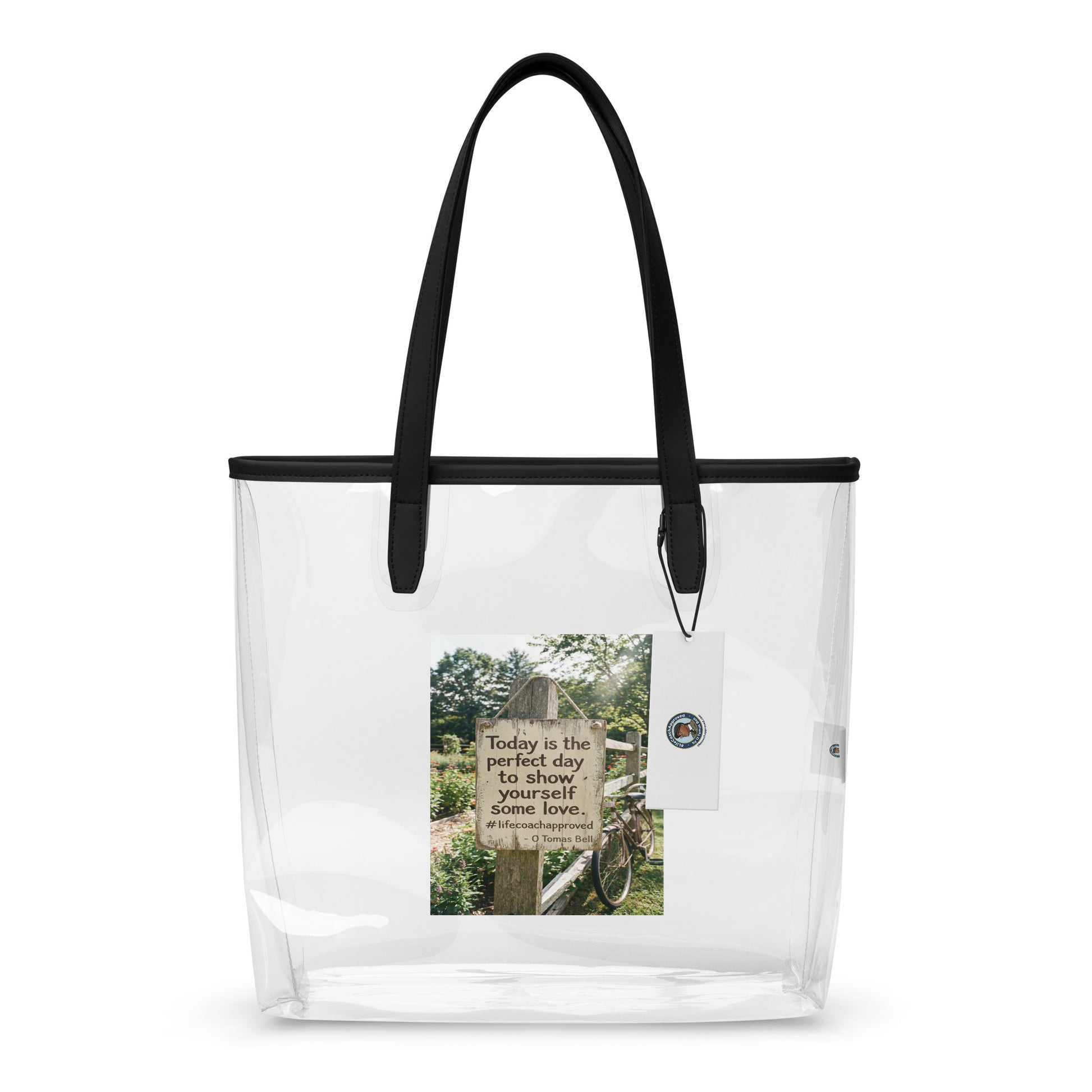 Clear tote bag with black handles and a printed inspirational panel on the front