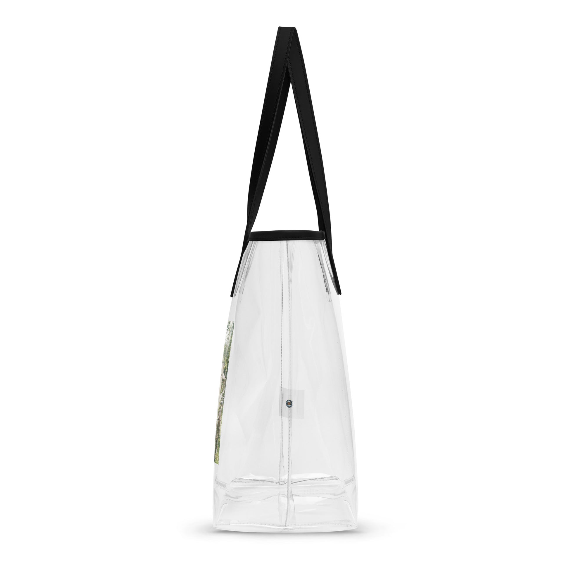 Clear tote bag with black handles, back side view with small circular logo detail