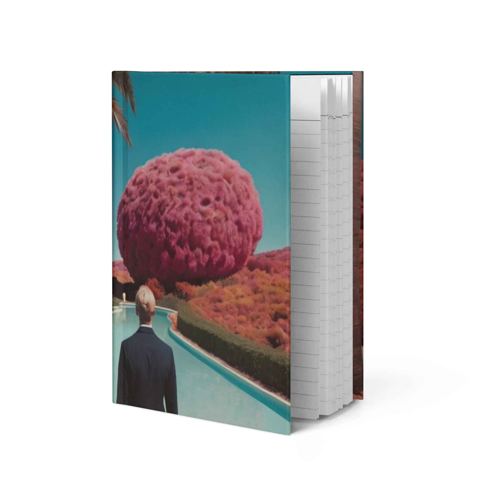 Opened matte hardcover journal showing lined pages beside printed landscape cover