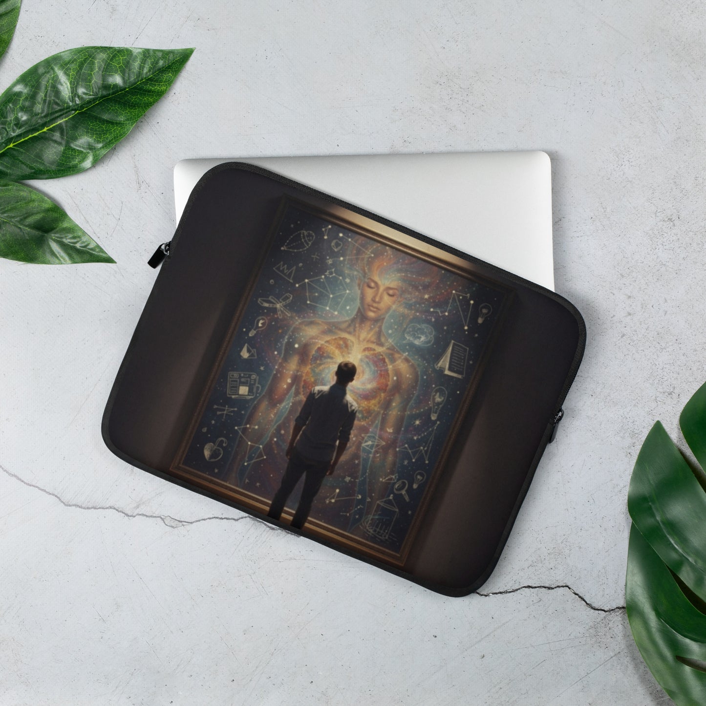Black laptop sleeve open to hold a light-colored laptop with celestial artwork