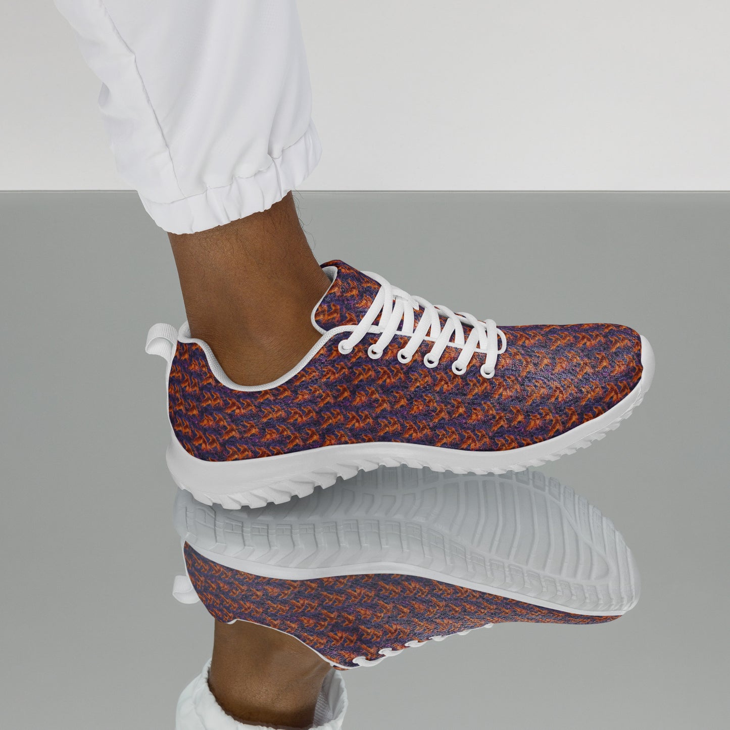 Close side view of athletic shoe with orange-and-blue knit upper and white tread sole