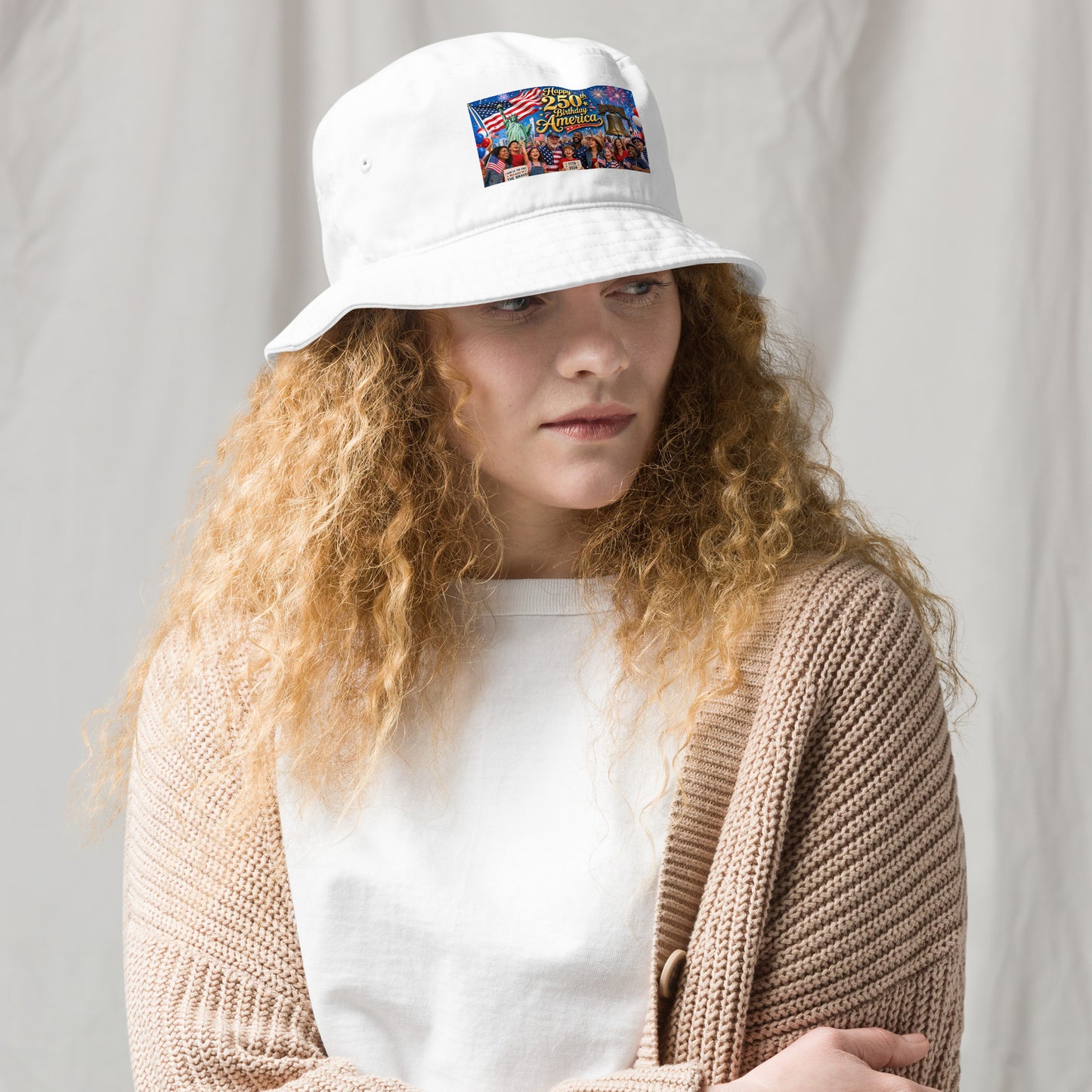 White organic bucket hat with front “250th Birthday America” patriotic graphic patch
