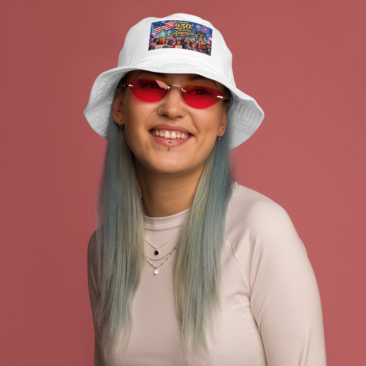 White organic bucket hat with “250th Birthday America” patriotic graphic patch, red sunglasses