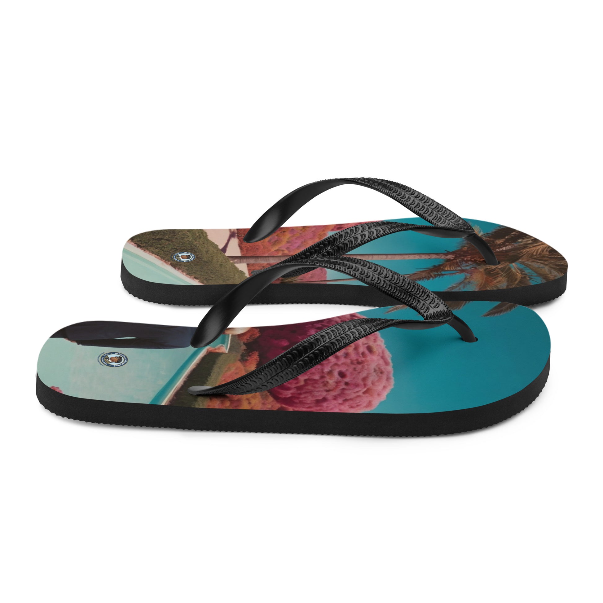 Printed flip-flops with black straps, thick cushioned sole, and multicolor landscape design