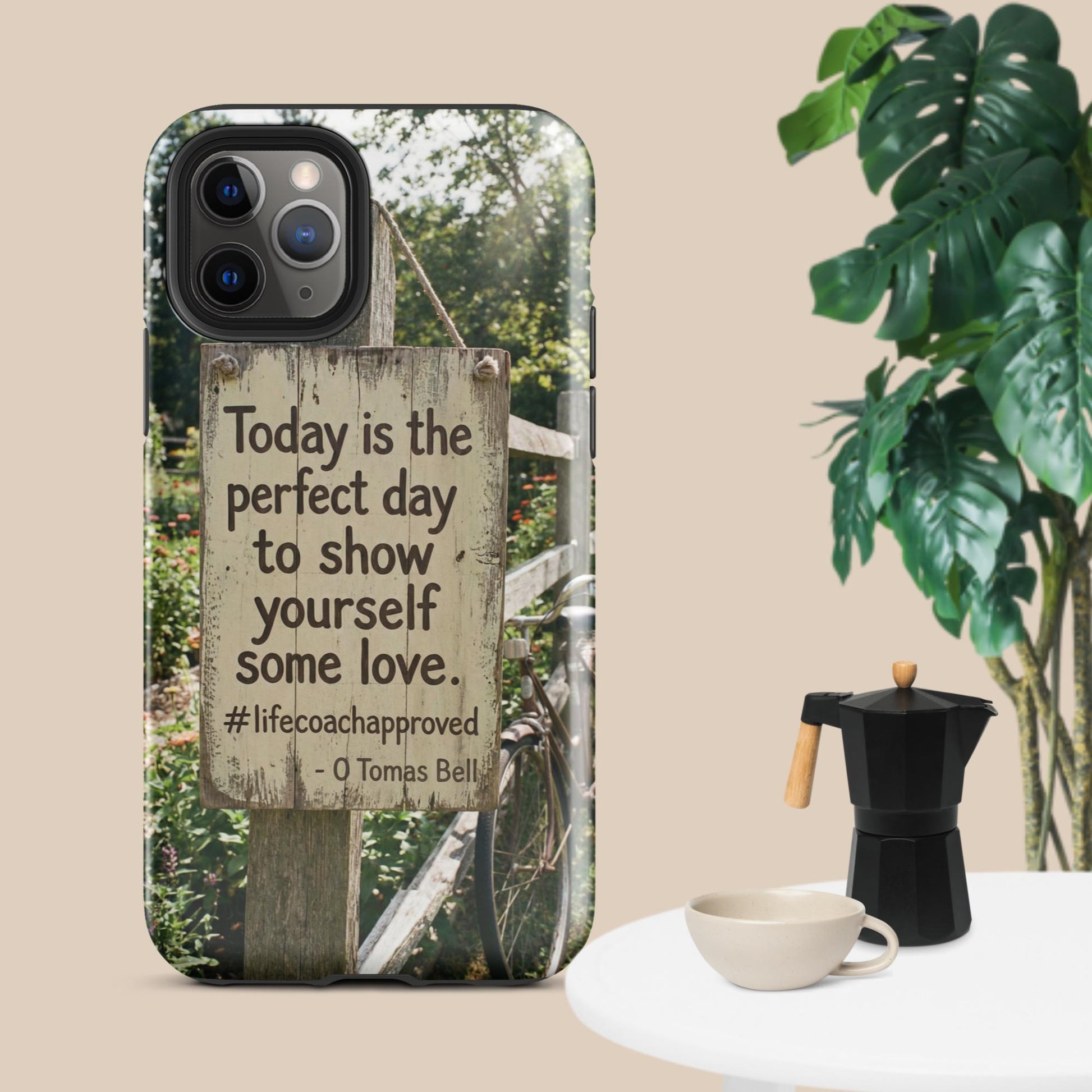 iPhone case with clear back, fence photo panel, and quote reading “some love.”