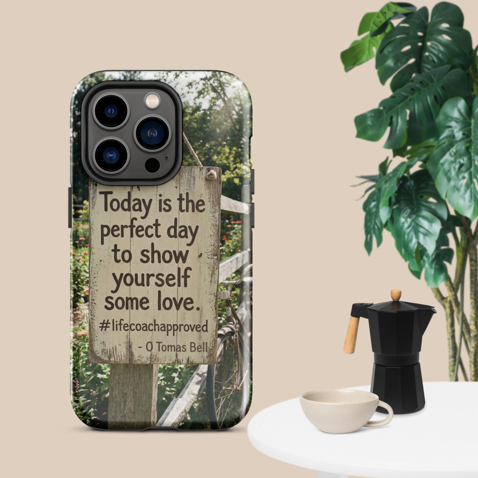 iPhone case with clear back, black camera border, and fence print with self-love quote