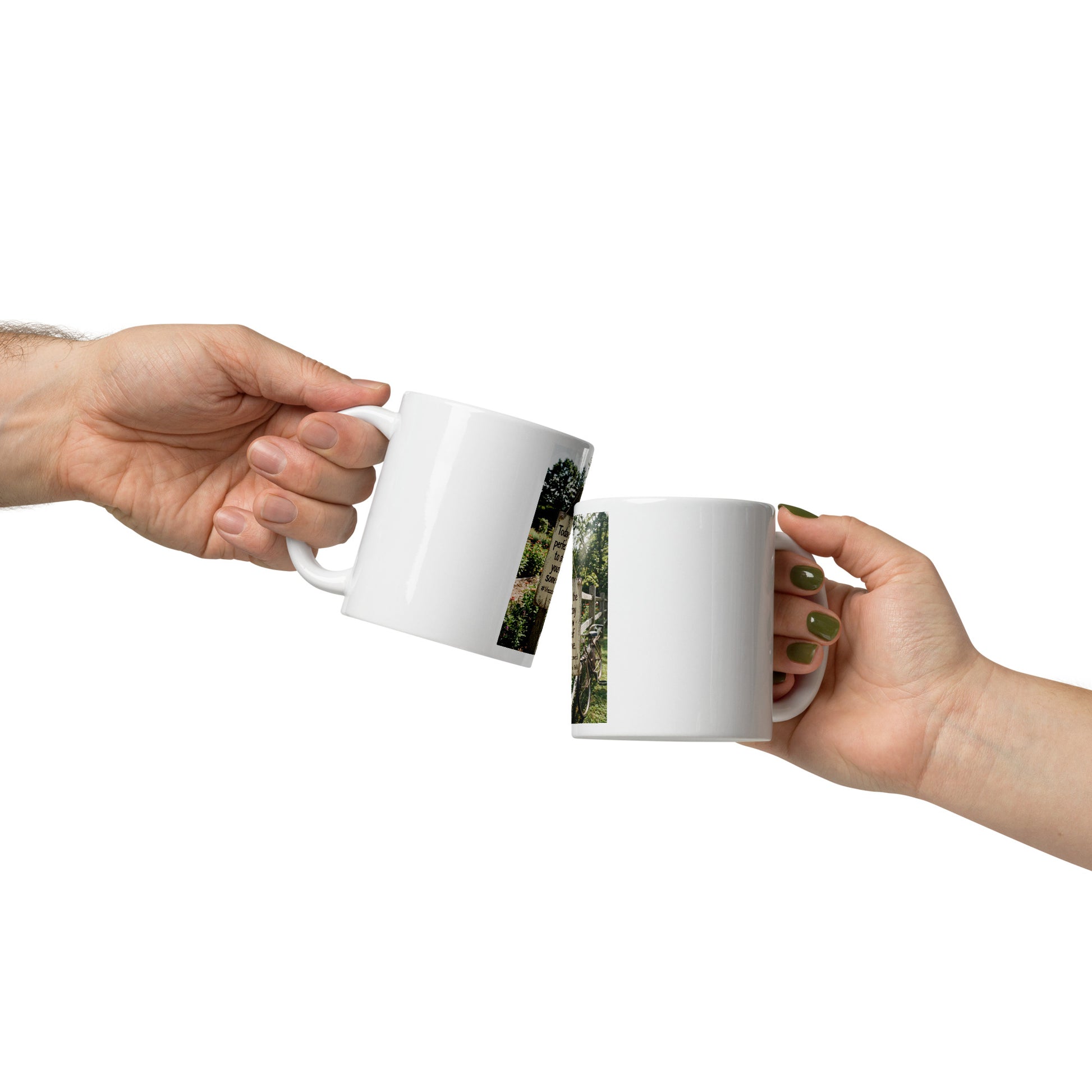 Pair of white glossy mugs in hands, front photo print on one mug, curved handles