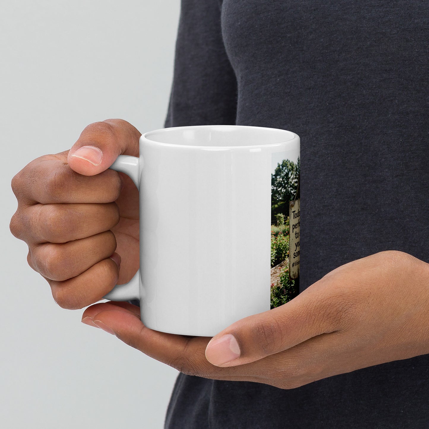 White glossy mug held by one hand, front graphic with quote panel