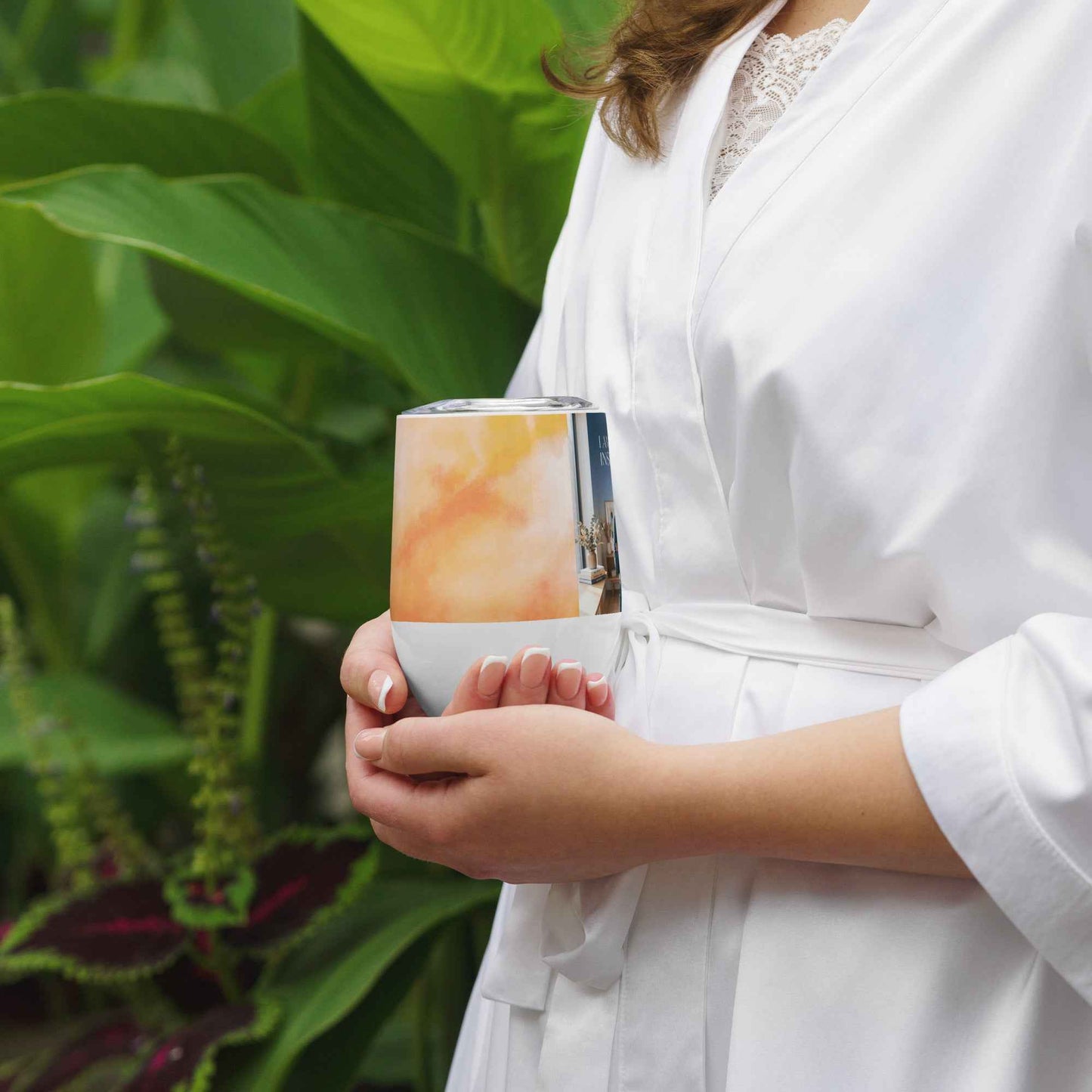 Wine tumbler with printed wrap and dark vertical side panel, held in hand