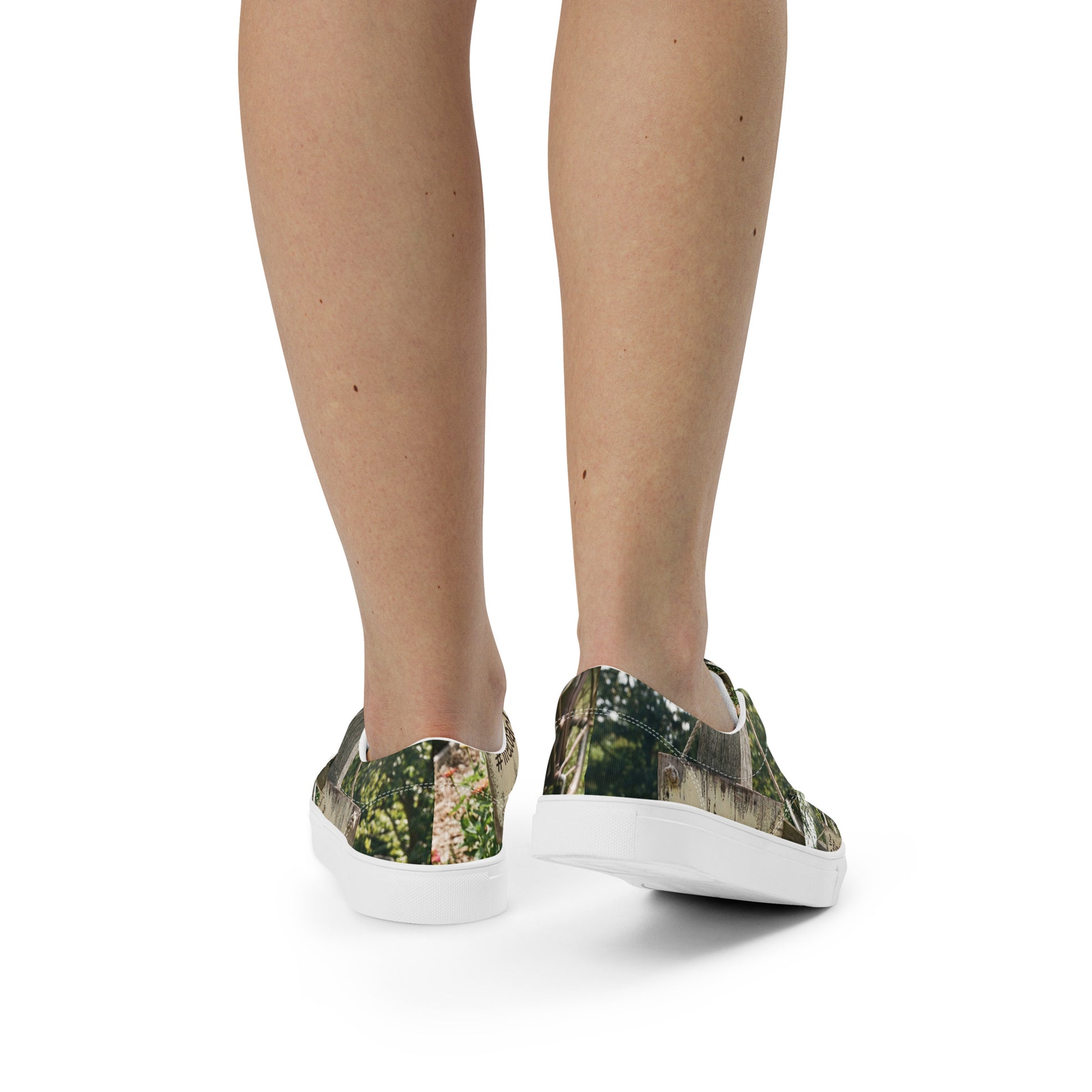 Rear view of canvas sneakers with woodland print, worn; white laces and white sole visible.