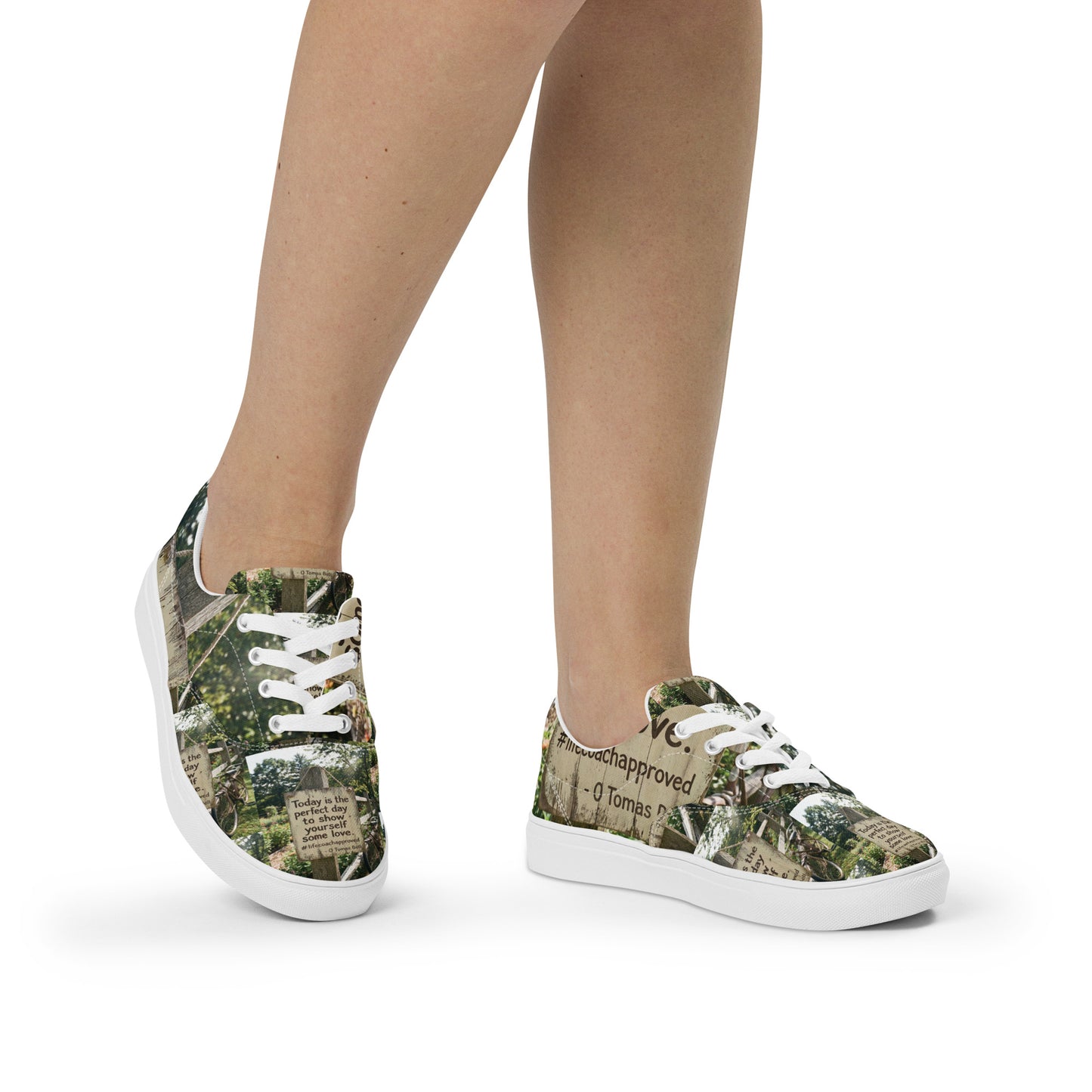 Canvas lace-up sneakers with woodland print upper and white sole, worn with bare legs.