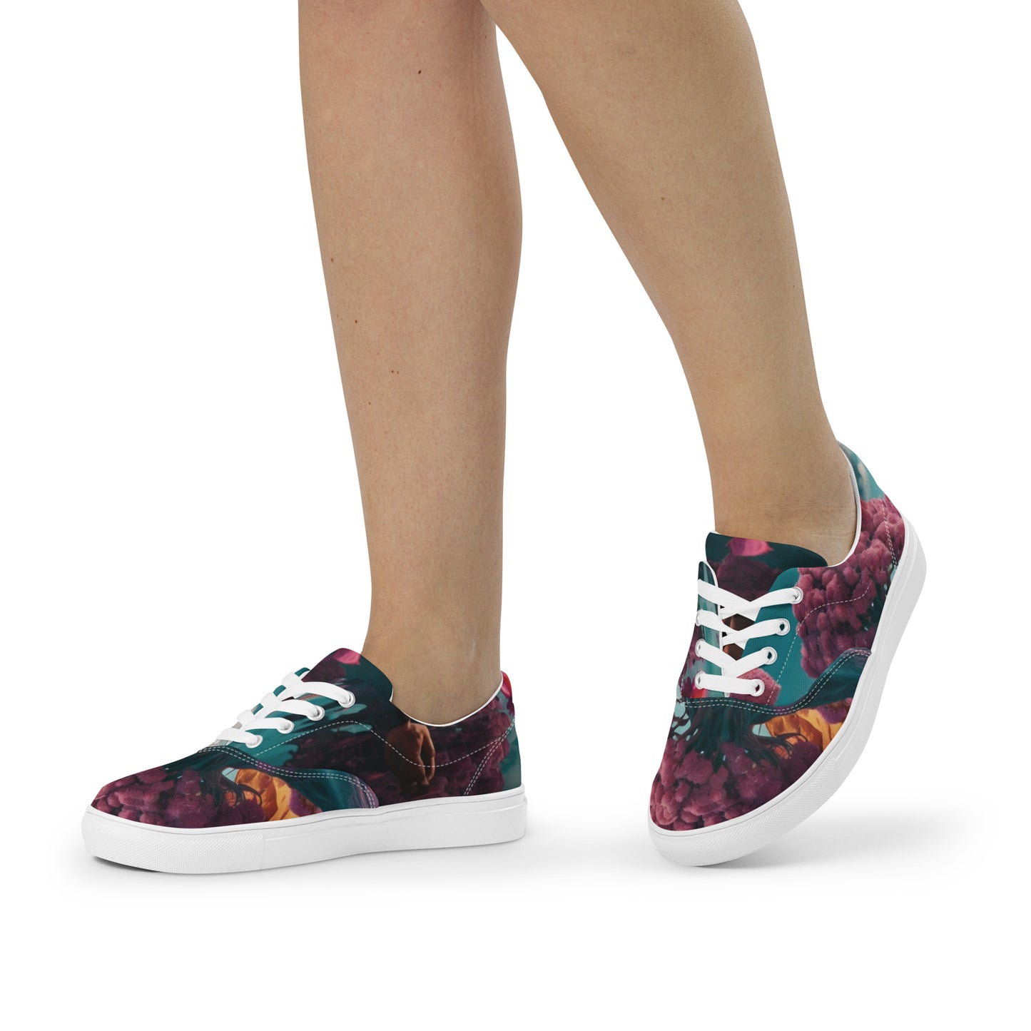 Pair of lace-up canvas sneakers showing floral uppers in teal and dark berry with white sole