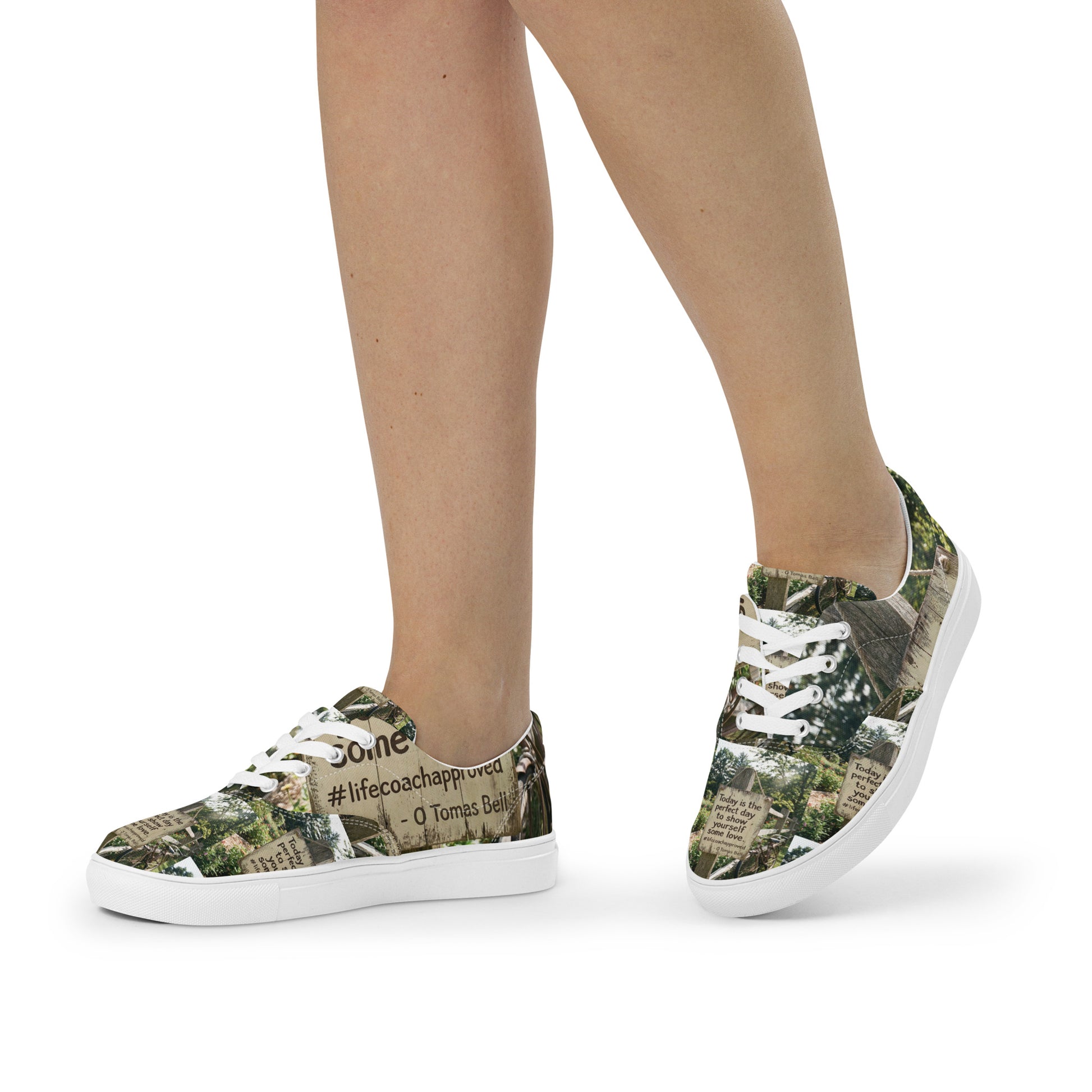Low-top canvas sneakers with woodland print, worn; white laces and white sole visible.