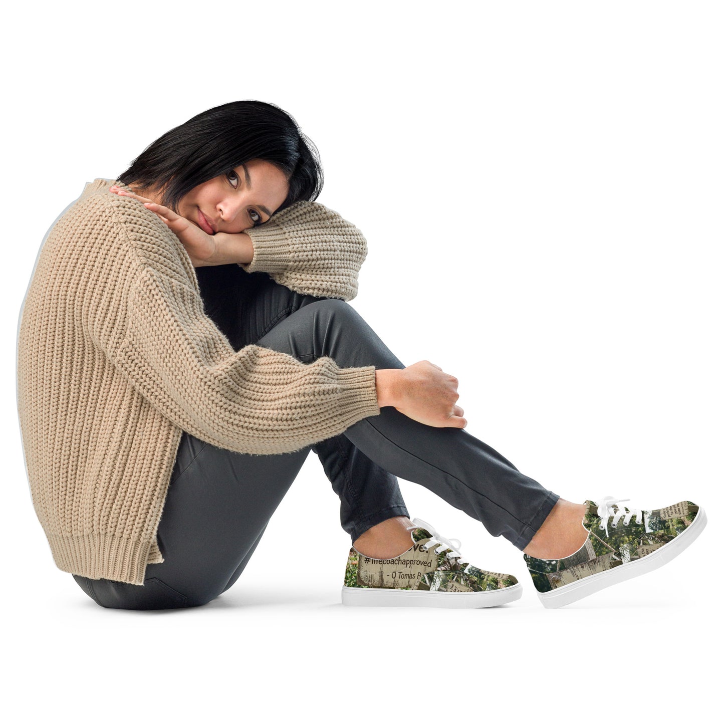 Canvas sneakers with woodland print, worn with casual pants; white laces and sole visible.